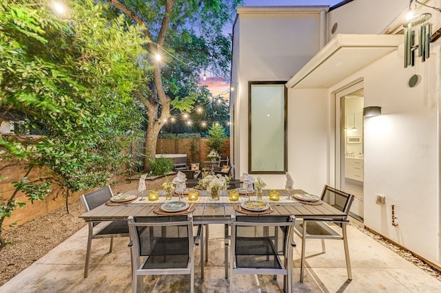 view of patio terrace at dusk