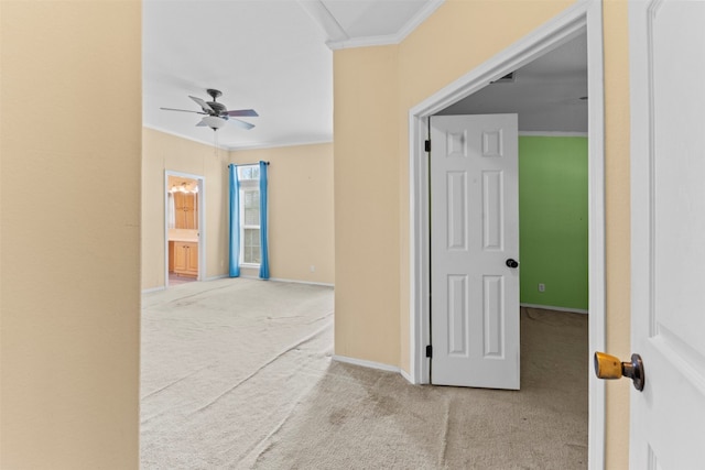 corridor with ornamental molding and light colored carpet