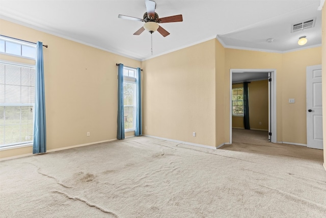 empty room featuring light colored carpet, ceiling fan, and crown molding