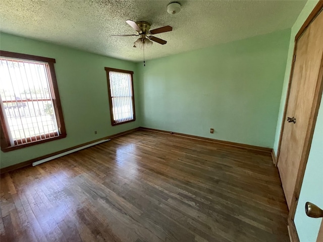 spare room featuring dark hardwood / wood-style flooring, ceiling fan, and a textured ceiling