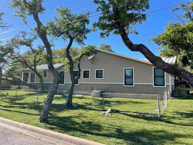 view of front of home featuring a front lawn and central air condition unit