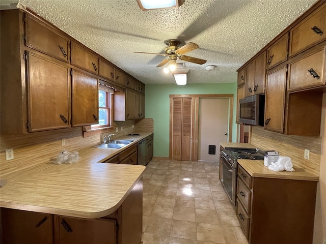 kitchen with ceiling fan, stainless steel appliances, tasteful backsplash, sink, and light tile floors