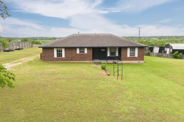 rear view of property with a lawn