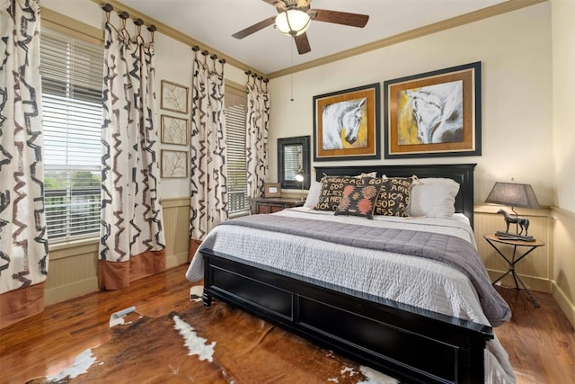 bedroom featuring ceiling fan, crown molding, and dark wood-type flooring