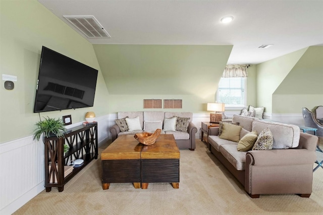 living room with light colored carpet and lofted ceiling