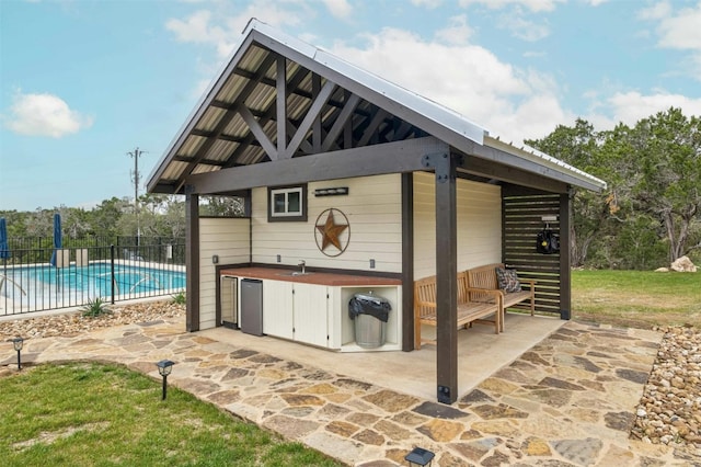 view of patio / terrace featuring a gazebo and a pool with hot tub