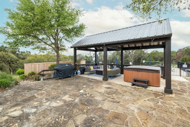 view of patio / terrace with a hot tub, a gazebo, and grilling area