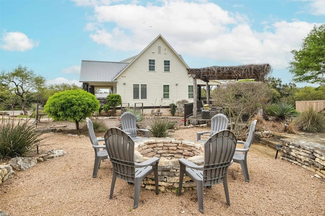 exterior space with a patio area, an outdoor fire pit, and a pergola