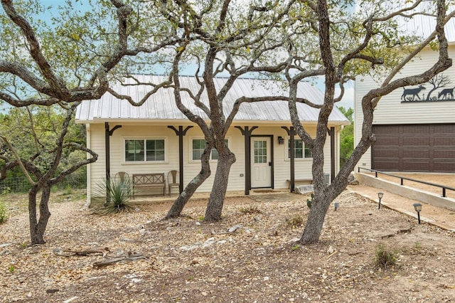 ranch-style house featuring a garage and a porch