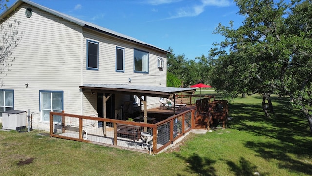 rear view of house featuring a yard