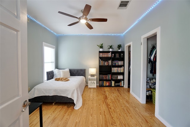 bedroom featuring light hardwood / wood-style flooring, a closet, and ceiling fan