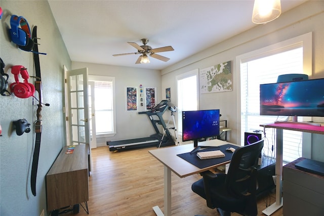 office space with light hardwood / wood-style floors and ceiling fan