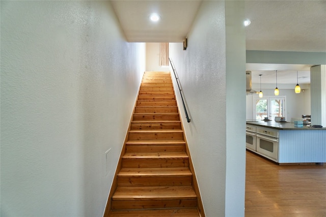 staircase featuring wood-type flooring