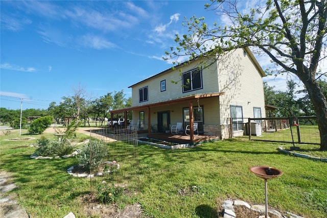 back of house with a lawn