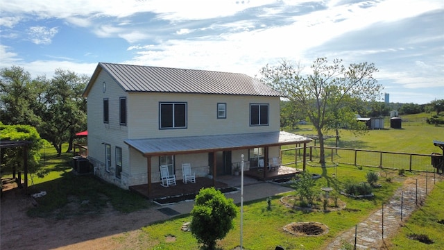 farmhouse-style home with covered porch and a front lawn