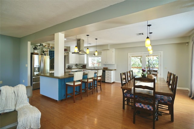 dining room with sink, dark hardwood / wood-style flooring, and french doors