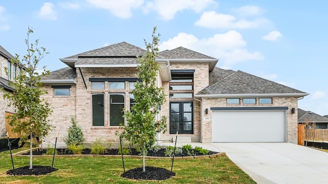 view of front of property featuring a front yard and a garage