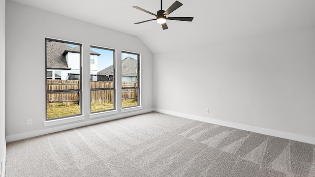 interior space with ceiling fan, carpet flooring, and lofted ceiling