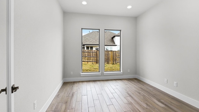 spare room featuring light wood-type flooring