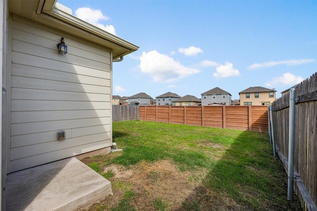 view of yard with a fenced backyard and a residential view