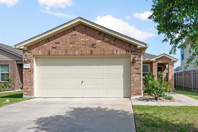 single story home with brick siding, driveway, an attached garage, and fence