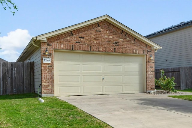 garage featuring driveway and fence