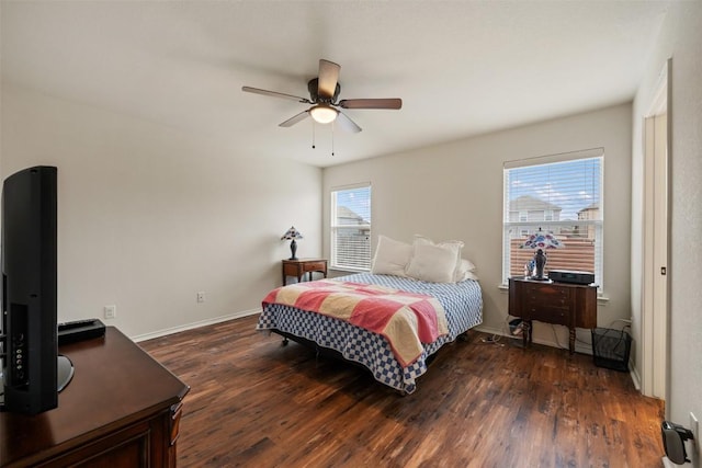 bedroom with ceiling fan, baseboards, and dark wood finished floors