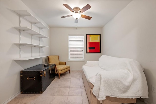 sitting room featuring light tile patterned floors, baseboards, and a ceiling fan