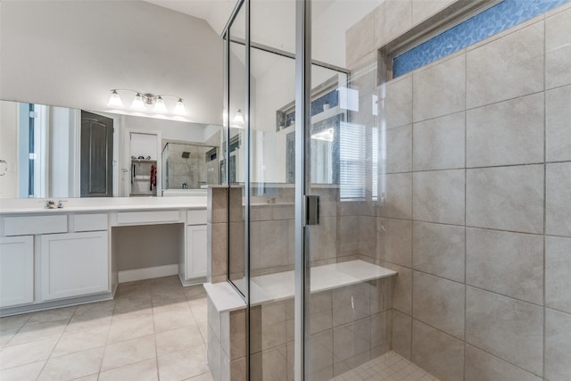 bathroom featuring vanity with extensive cabinet space, an enclosed shower, and tile flooring