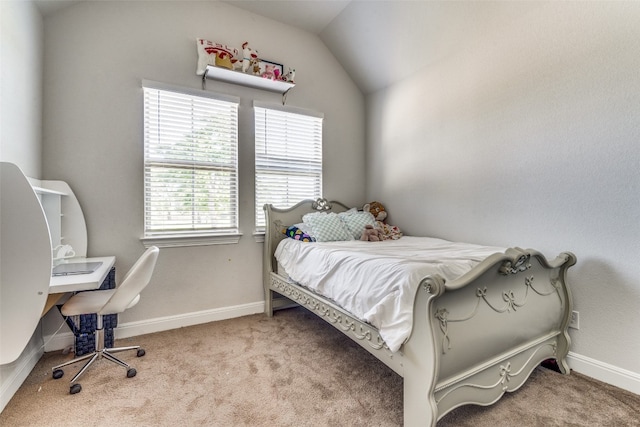 carpeted bedroom with lofted ceiling