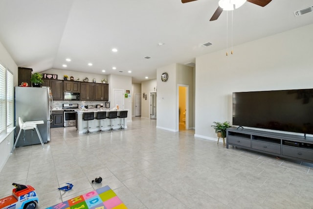 tiled living room featuring lofted ceiling and ceiling fan