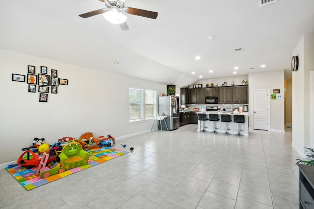 playroom with vaulted ceiling, ceiling fan, and light tile floors