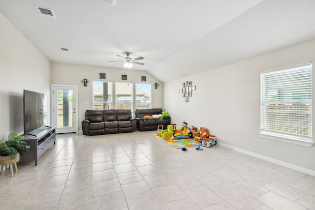 interior space with lofted ceiling, ceiling fan, and light tile floors