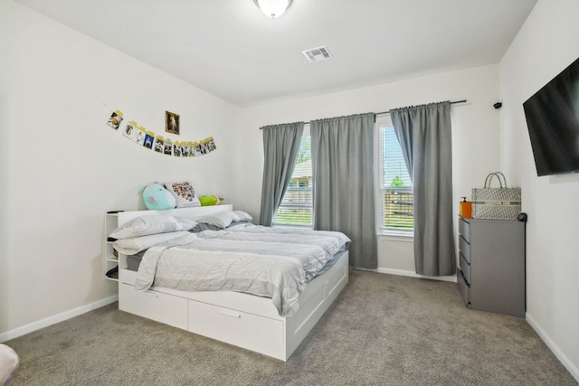 bedroom featuring light carpet