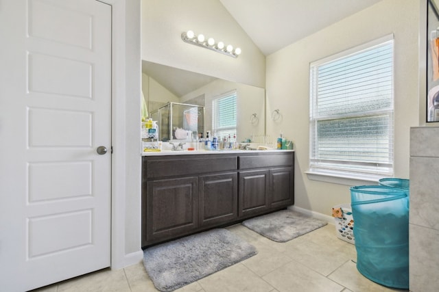 bathroom with vaulted ceiling, vanity, and tile flooring