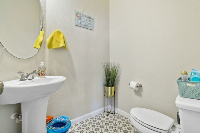 bathroom featuring tile floors and toilet