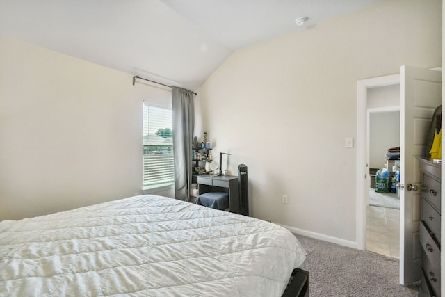 bedroom featuring light carpet and vaulted ceiling