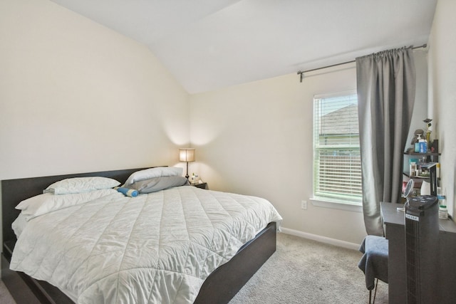 bedroom with light carpet and lofted ceiling