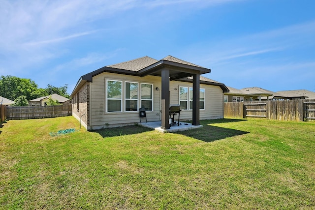 rear view of house with a patio and a lawn