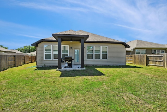 back of house featuring a patio, a lawn, and ceiling fan