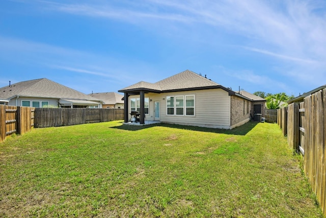 rear view of property with a lawn