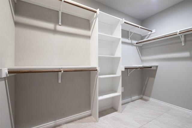 spacious closet featuring light tile flooring