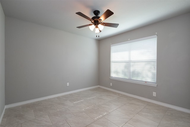 empty room featuring ceiling fan and light tile flooring