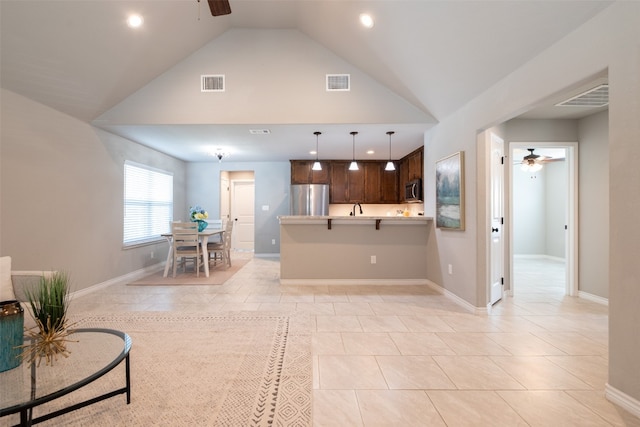 kitchen with high vaulted ceiling, dark brown cabinetry, appliances with stainless steel finishes, light tile floors, and ceiling fan