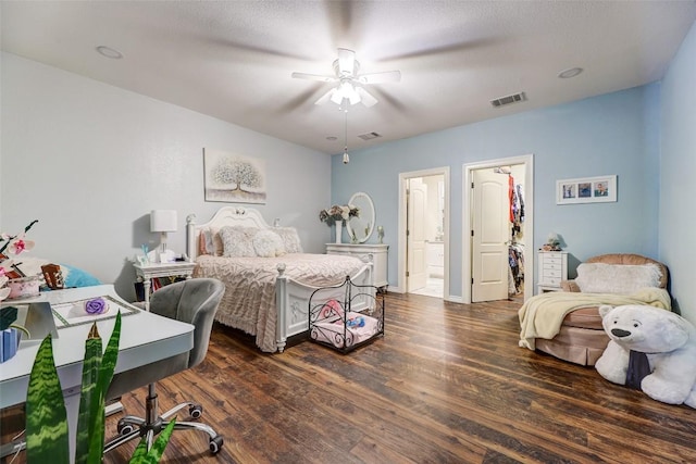 bedroom with connected bathroom, ceiling fan, and dark hardwood / wood-style floors