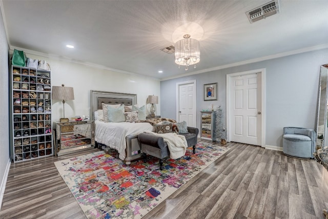 bedroom featuring a chandelier, hardwood / wood-style flooring, and ornamental molding