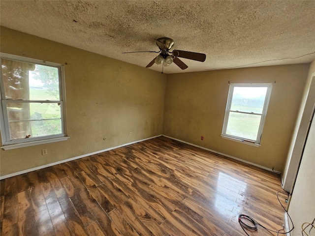 empty room featuring hardwood / wood-style flooring, ceiling fan, and a textured ceiling