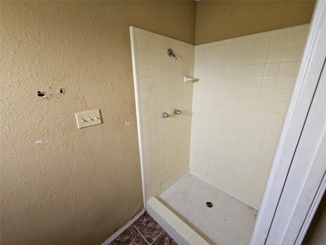 bathroom with a tile shower