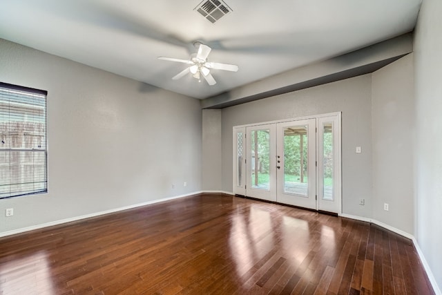 empty room with dark wood-type flooring, ceiling fan, and french doors