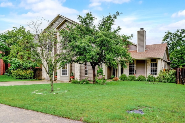 view of property hidden behind natural elements featuring a front lawn